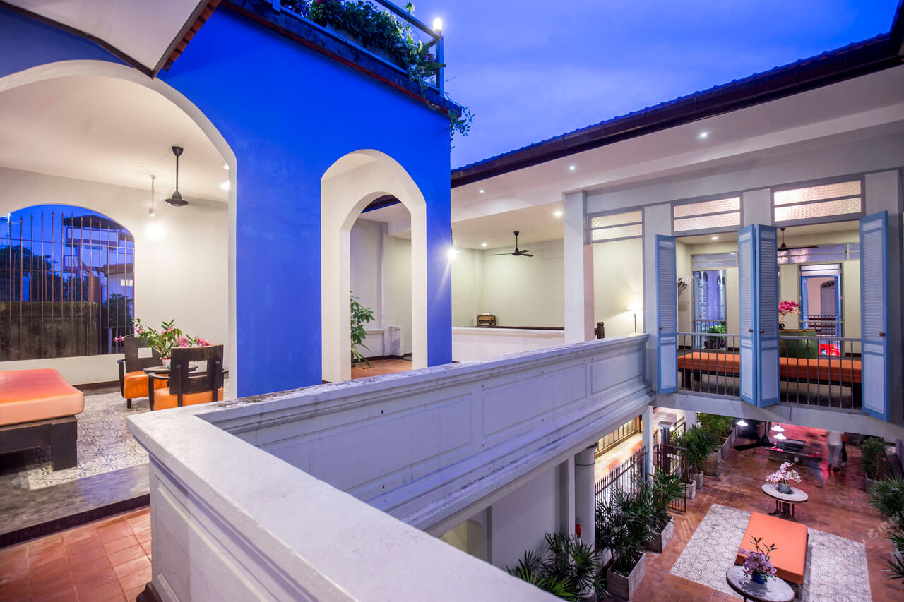 Upper-floor terrace overlooking the courtyard at dusk in the old Phuket building