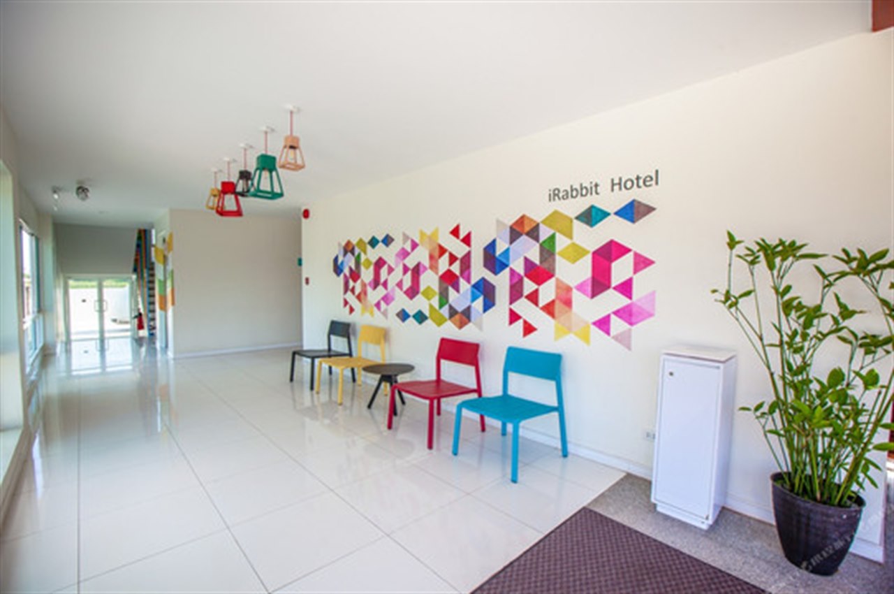 ล็อบบี้ iRabbit Hotel ผนังลายสามเหลี่ยมสีสันกับเก้าอี้สีสด