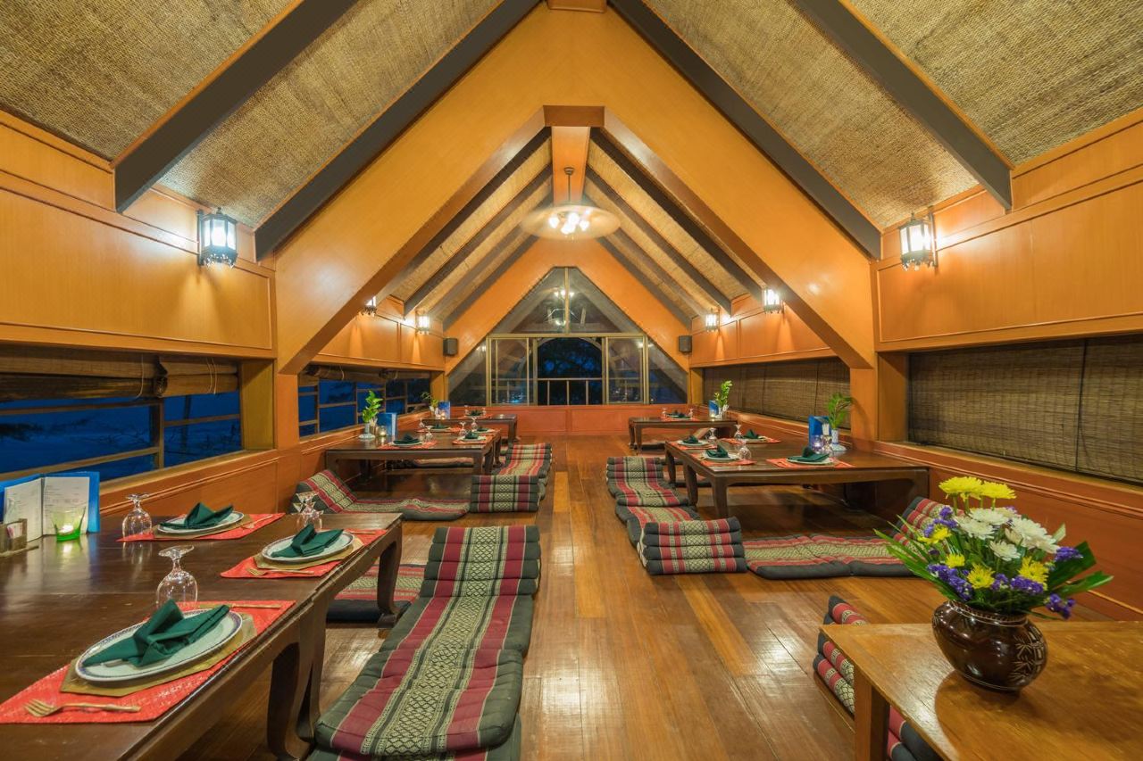 Pitched-roof restaurant with woven-bamboo ceiling and Thai floor seating