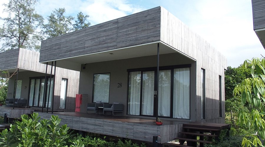Grey timber flat-roofed Bauhaus-style bungalow at Cede Boutique Beach Resort, Koh Phayam