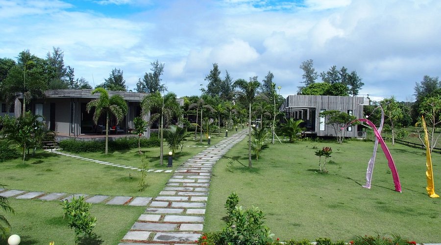 Lawn and stone path running between the resort's bungalows