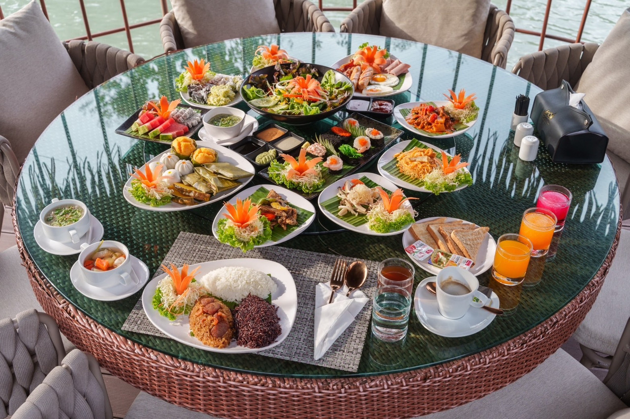 A lakeside breakfast spread laid out on the water's edge at Khum Damnoen Resort