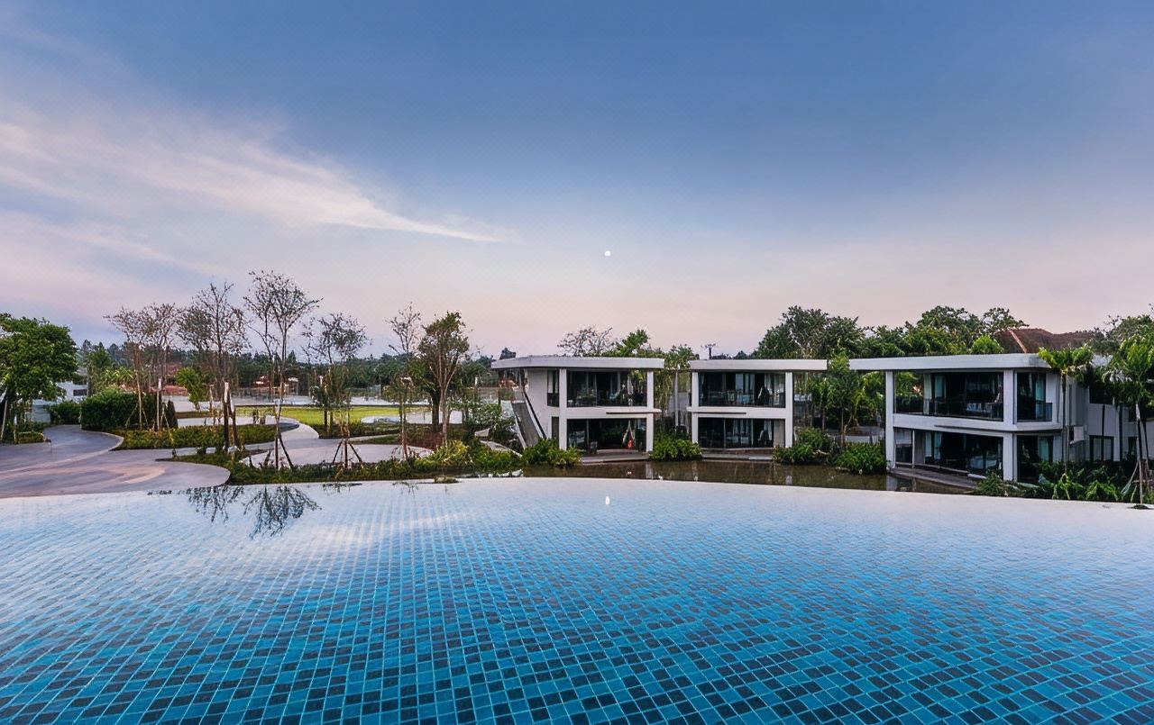 Na Tree Tara infinity pool with the curved white guest wing at dusk