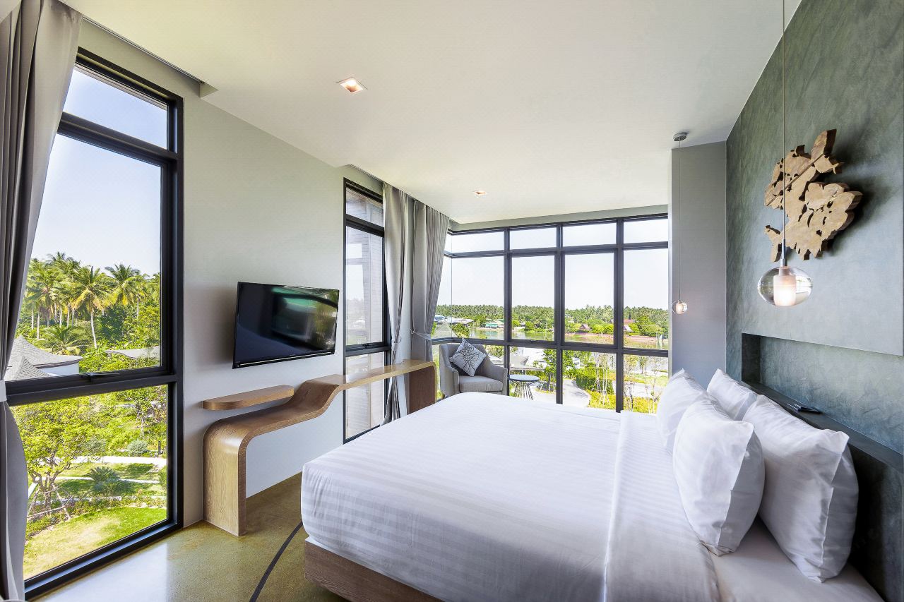 Guest room with floor-to-ceiling windows and garden and Mae Klong river views