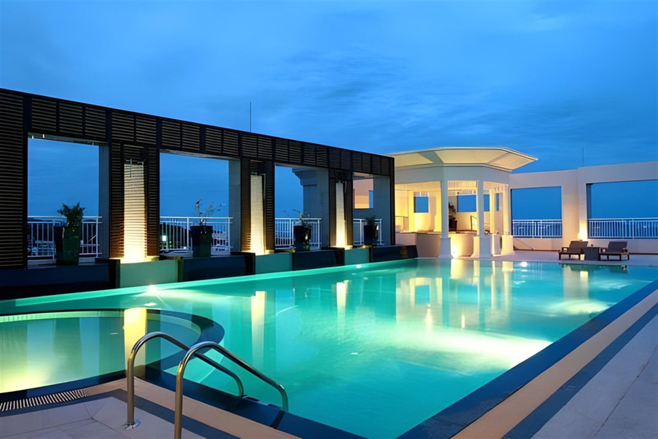 Rooftop swimming pool with Gulf of Thailand views at dusk