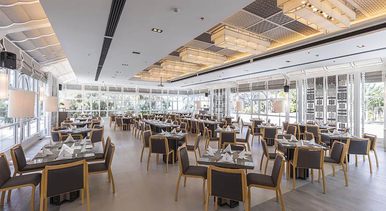 Italian-styled restaurant with floor-to-ceiling windows facing the garden
