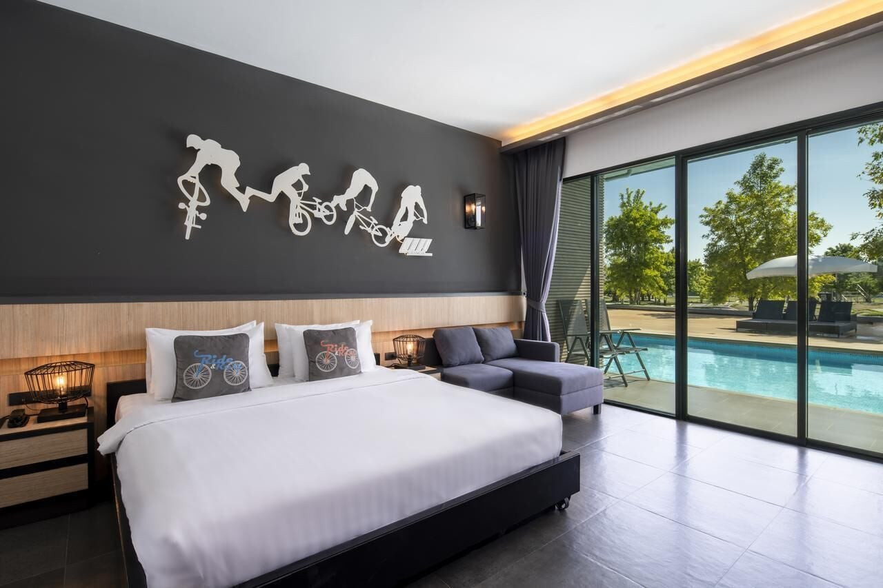 Modern guest room with BMX rider wall art and a balcony facing the pool