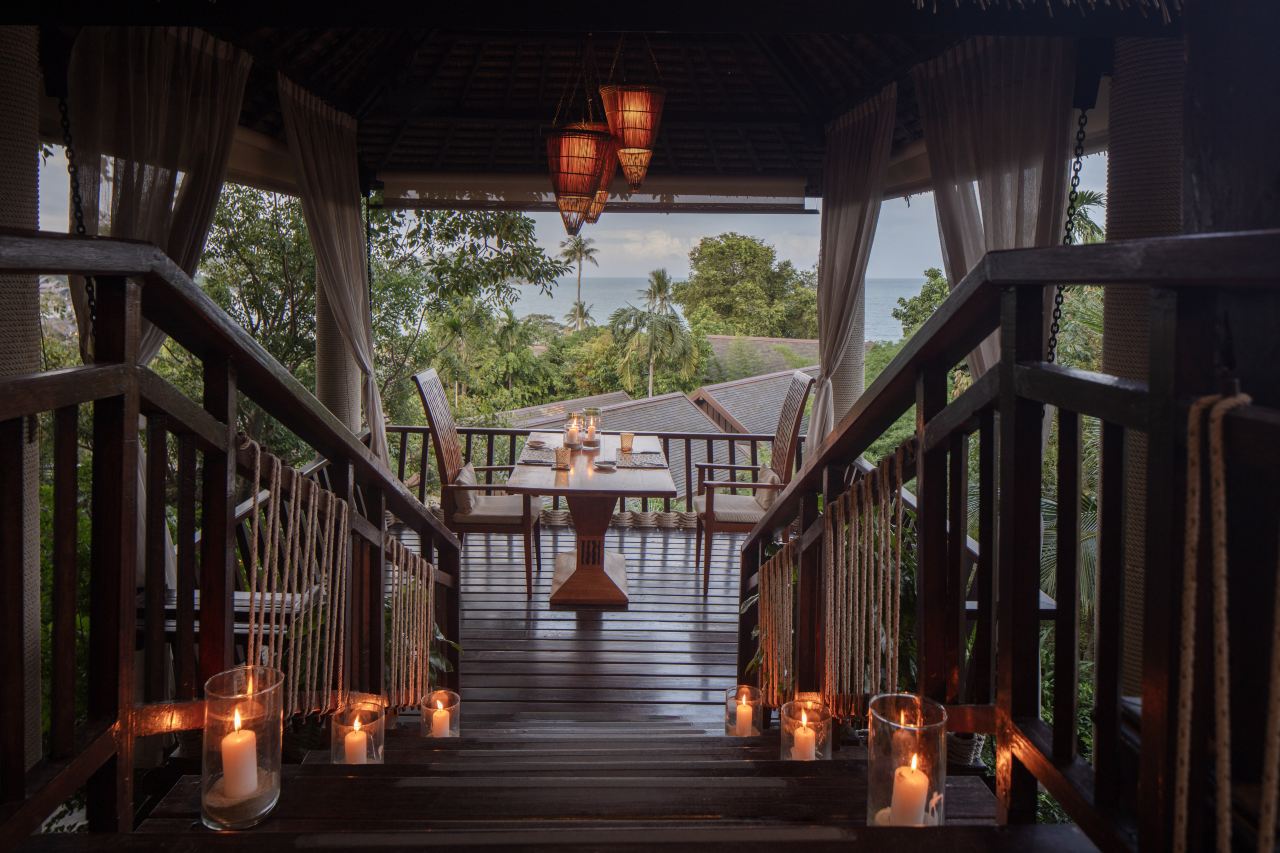 Tree Tops canopy dinner setting lit by candles at dusk