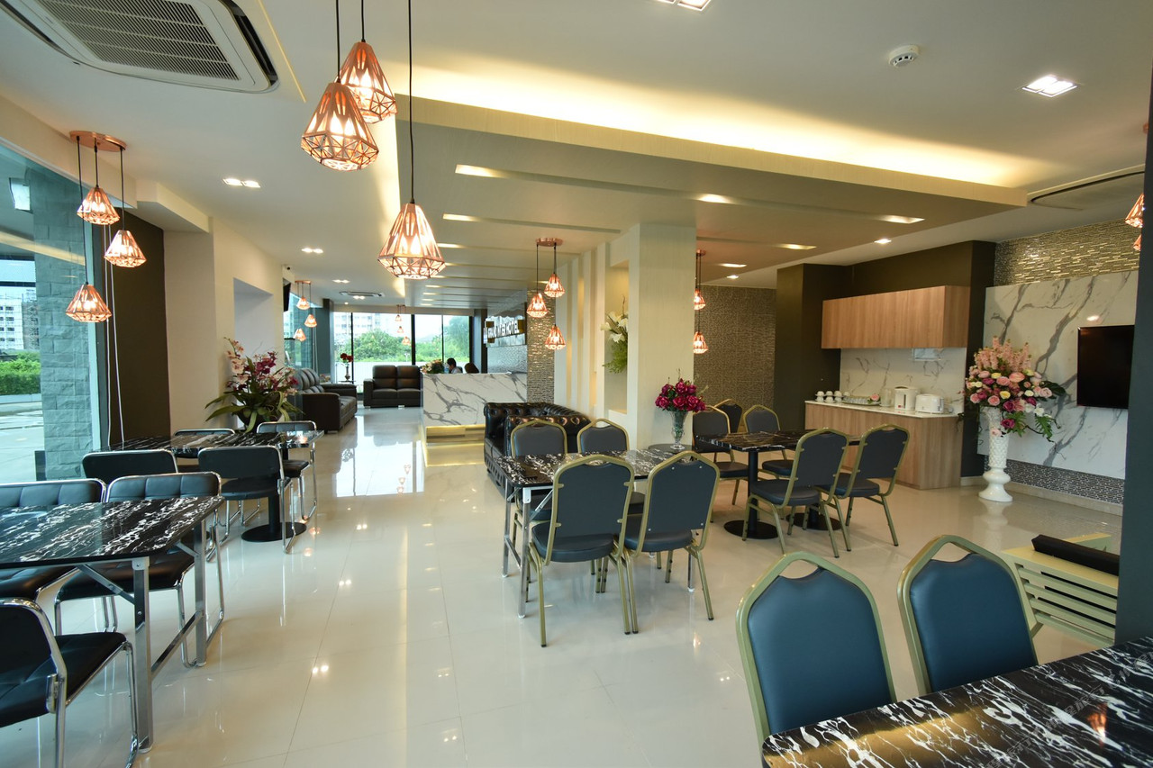 Lobby and lounge with marble tables, copper pendant lights and reception desk