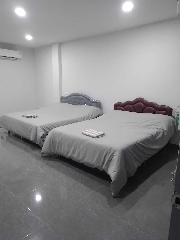Twin family room with two beds, polished-stone floor and air-conditioning
