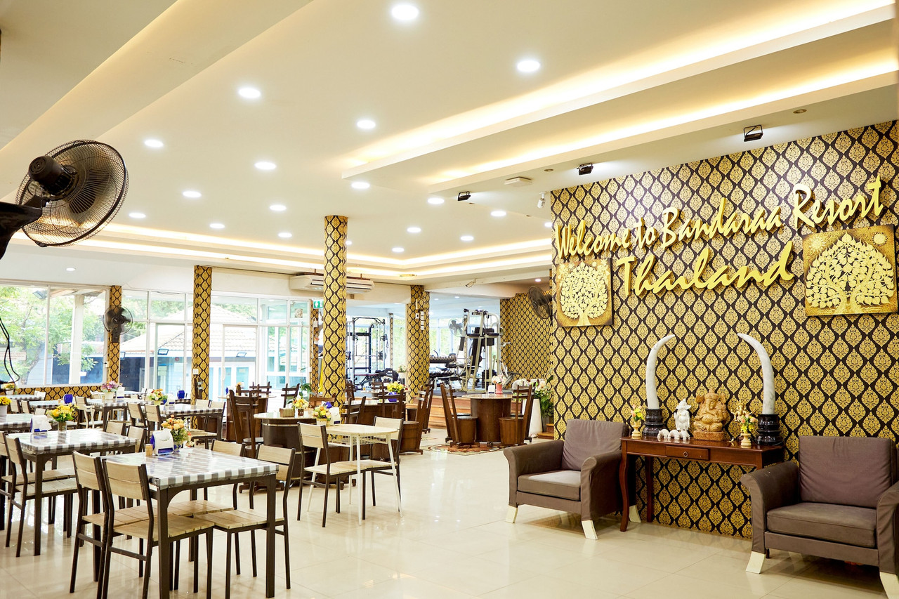 Resort restaurant and lobby with a wall reading Welcome to Baandara Resort
