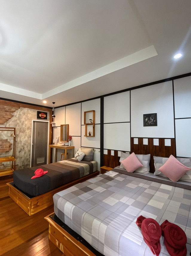 Guest room with a stone accent wall, timber screens and a king bed with an extra single