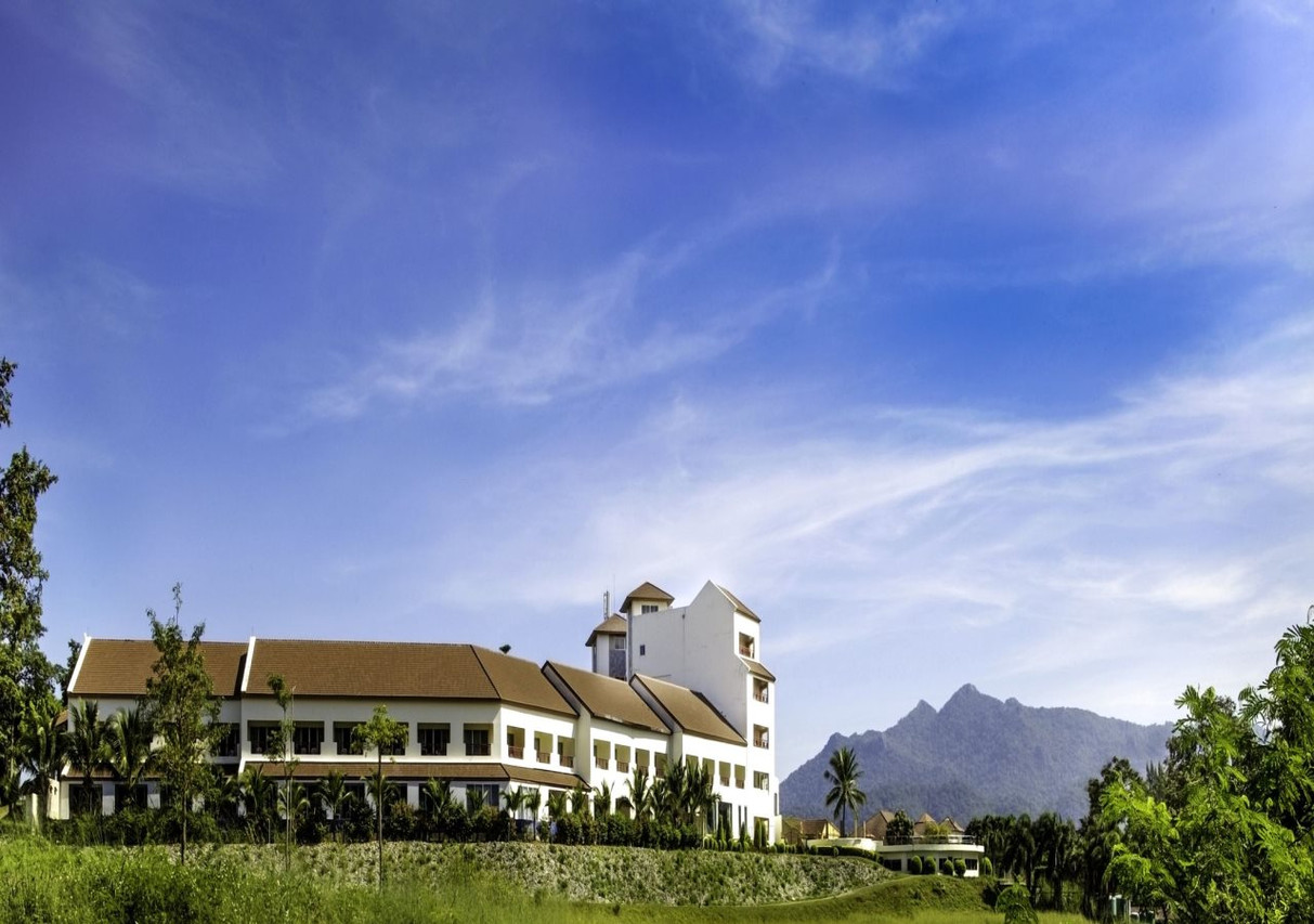 Sir James Resort building with a small tower against the Khao Yai mountains