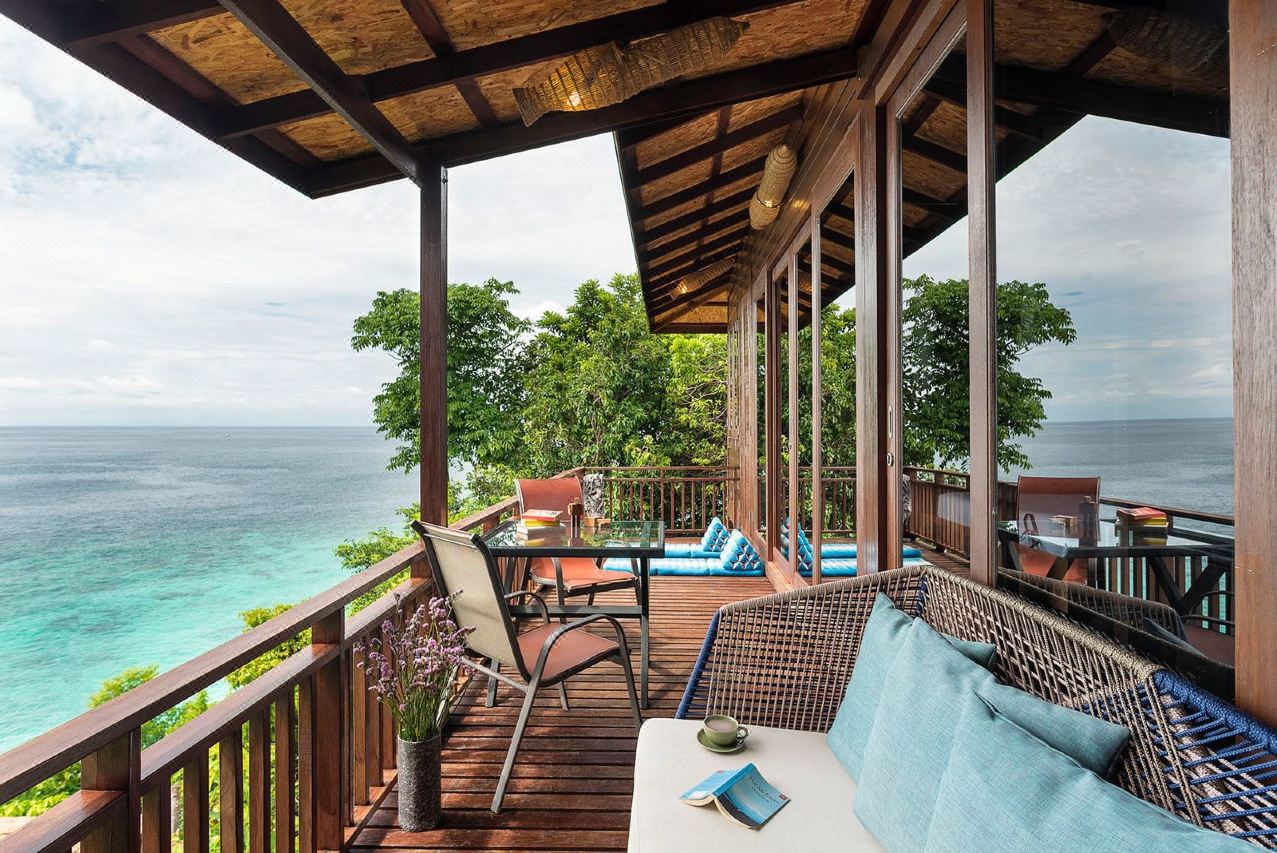 Wooden villa deck at Serendipity Koh Lipe overlooking the Andaman Sea from the cliff