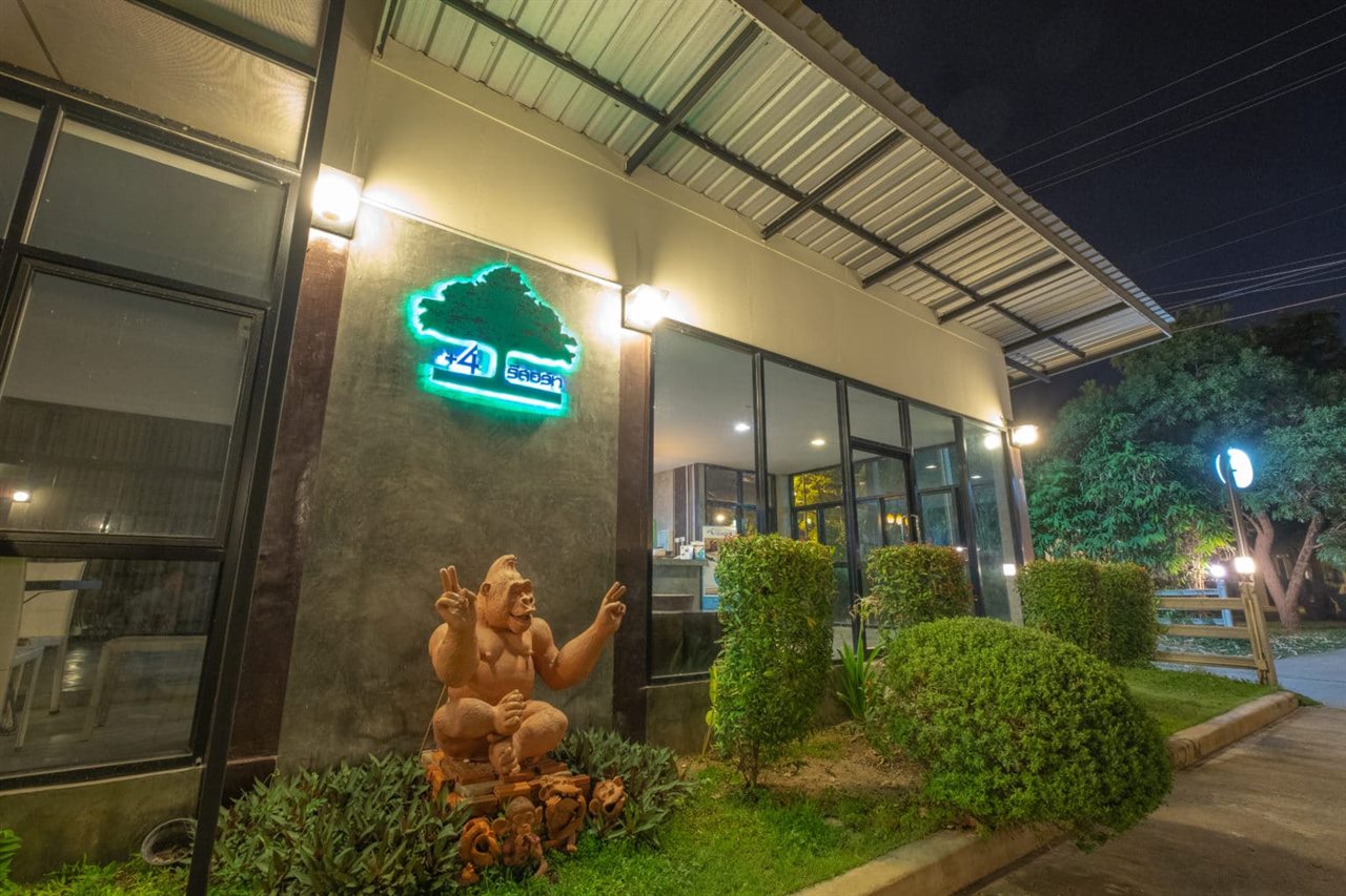 Entrance and lit +4 Resort sign at night