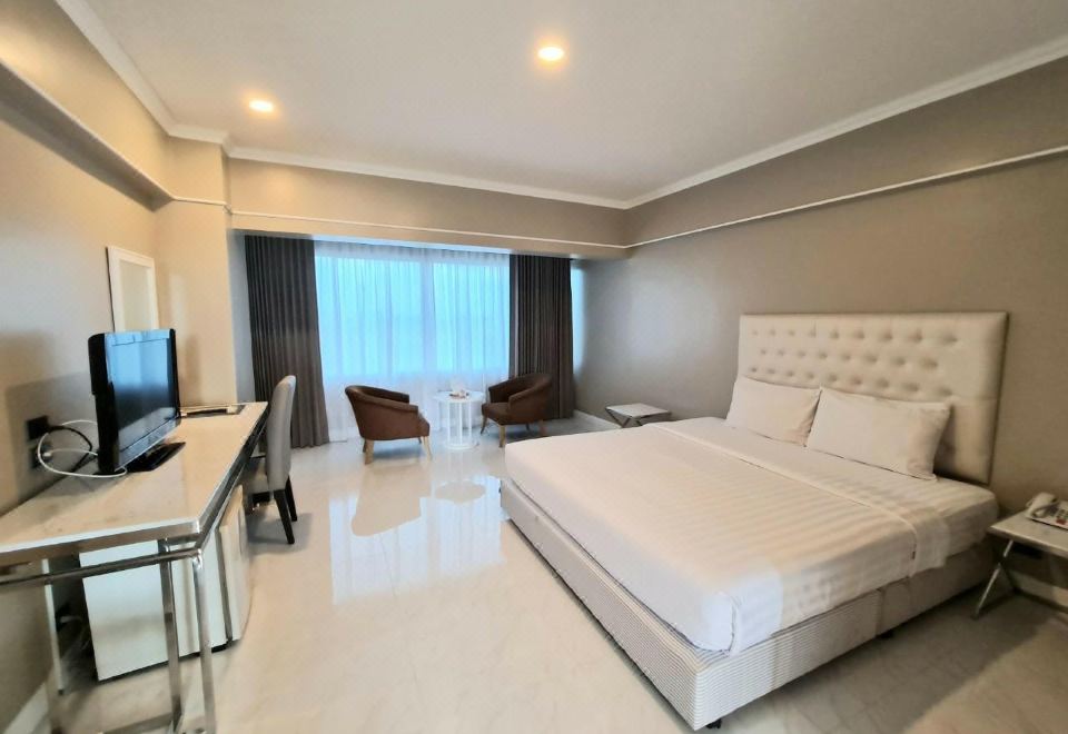 Deluxe king room with marble floor and a window sitting nook