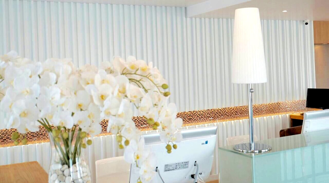 Cafe-style lobby with white orchids on the reception counter