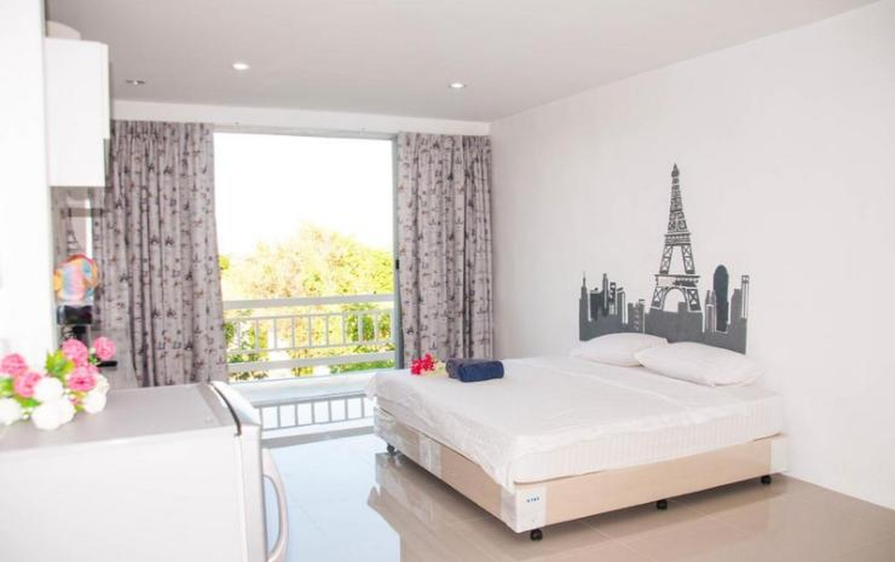 Heyday Singburi guest room with a city/Eiffel wall mural and a garden-view balcony
