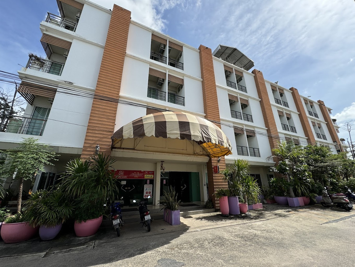 Hotel exterior by day with orange brick pillars and the entrance canopy