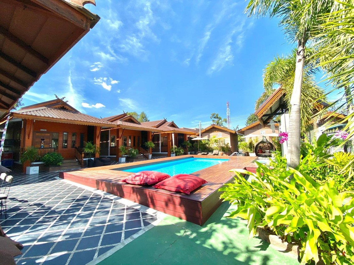 Saltwater pool with Lanna teak houses at Khum Lanna Sisaket