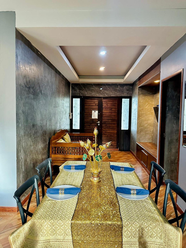 In-room dining table set with Thai gold runner at Khum Lanna