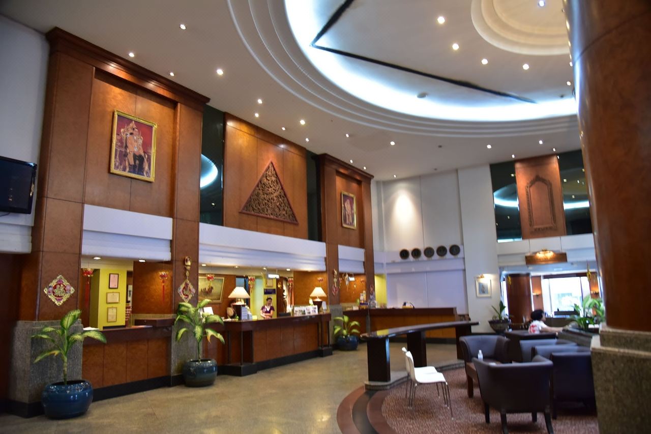 BP Grand Tower Hat Yai lobby with copper-clad columns and carved Thai woodwork