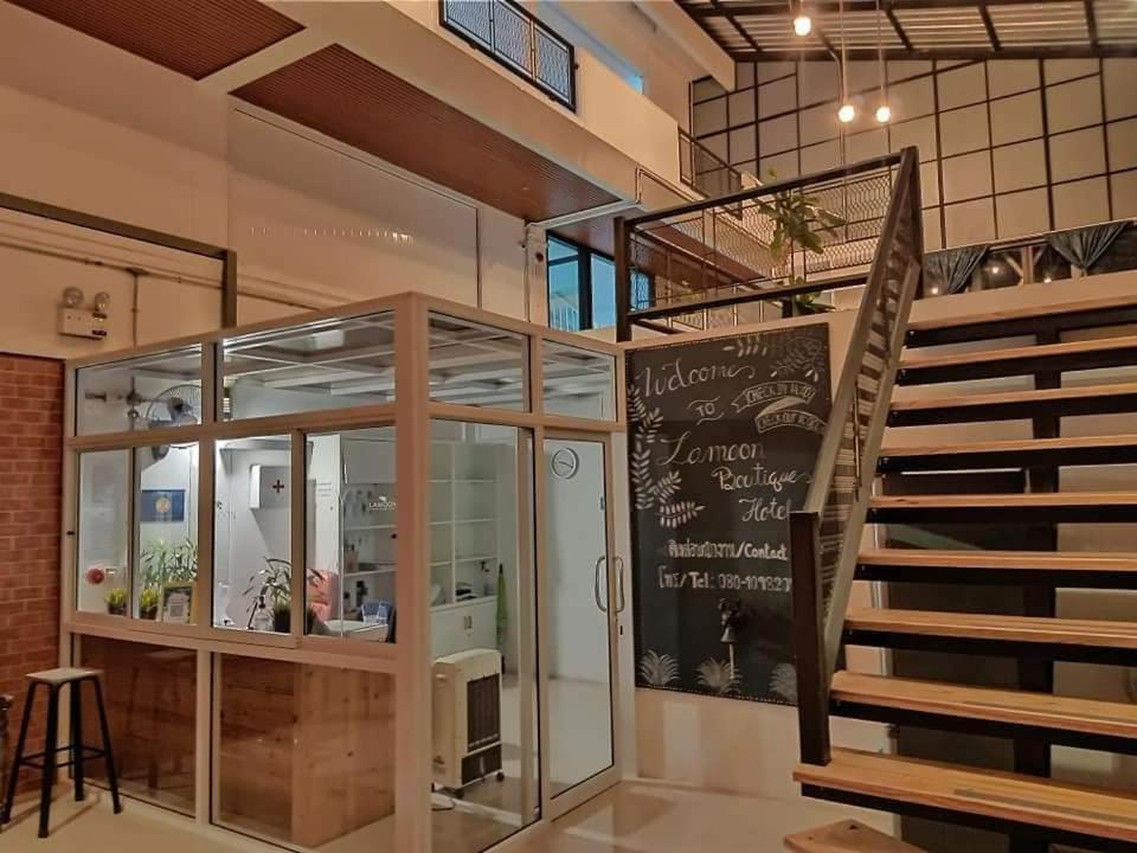 Lobby and reception desk at Lamoon Boutique Hotel with a hand-lettered welcome chalkboard