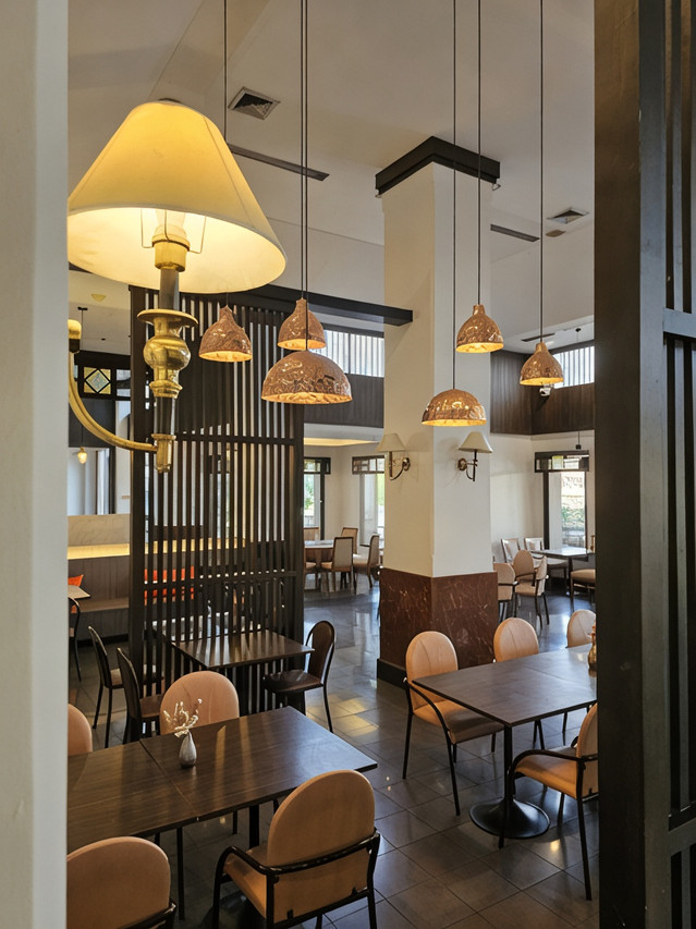 Hotel restaurant with woven pendant lamps and Thai-style wooden screens