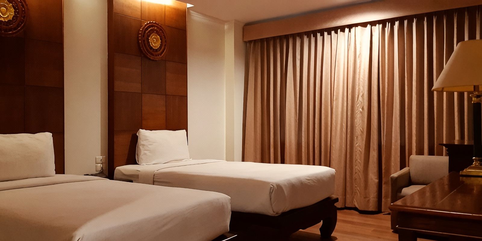 Twin guest room with carved teak Thai-motif headboard