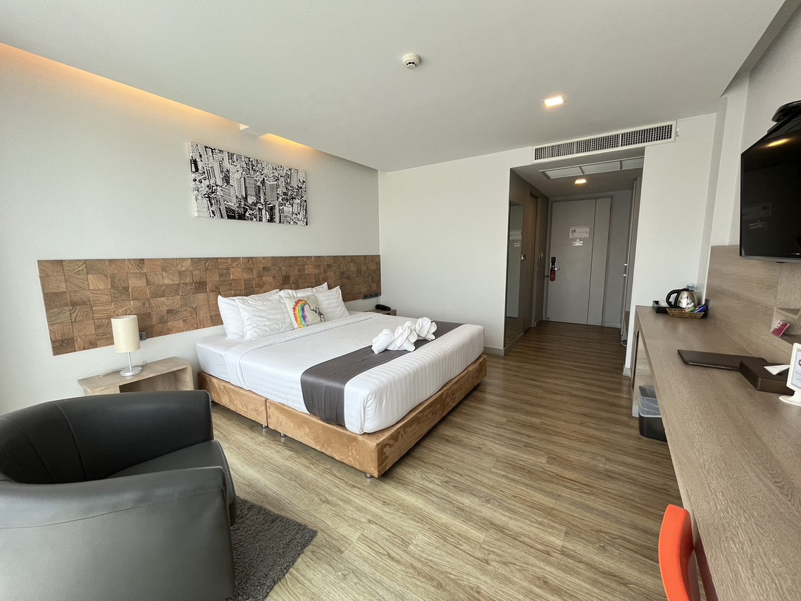 Modern wood-floor guest room with a king bed at Slive Hotel Surin