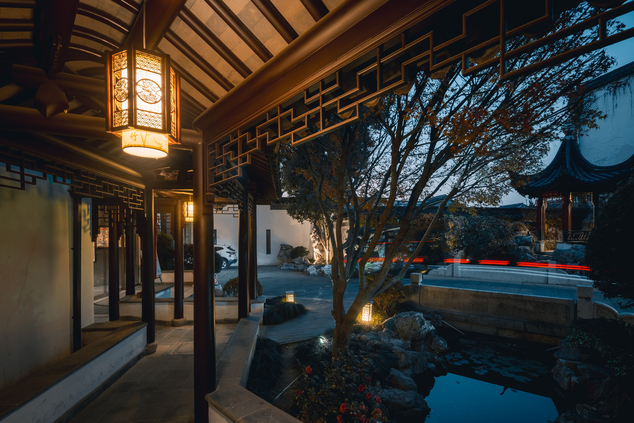A covered walkway beside the water garden, koi pond and timber pavilion inside the hotel