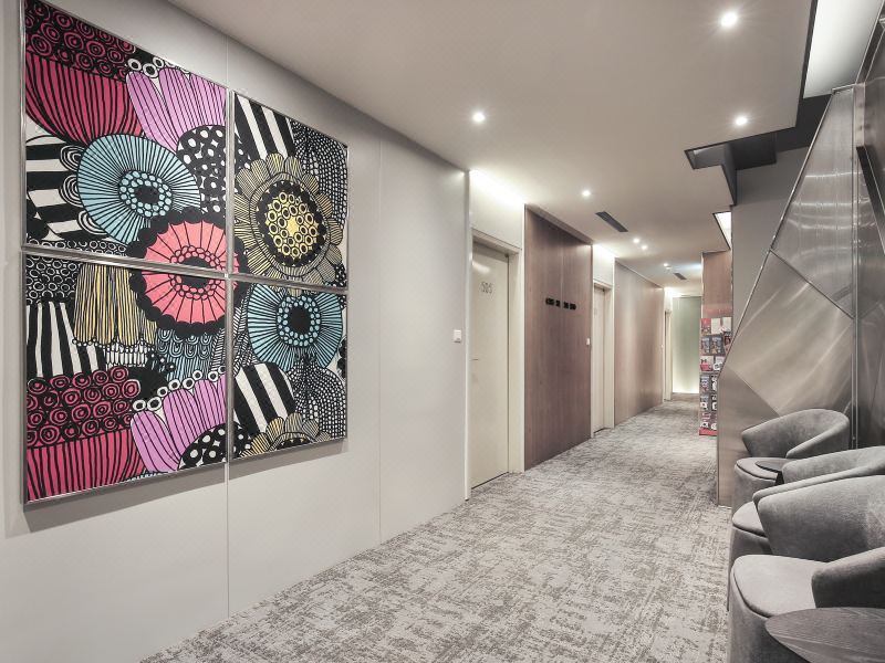 Lounge seating and corridor to the renovated rooms