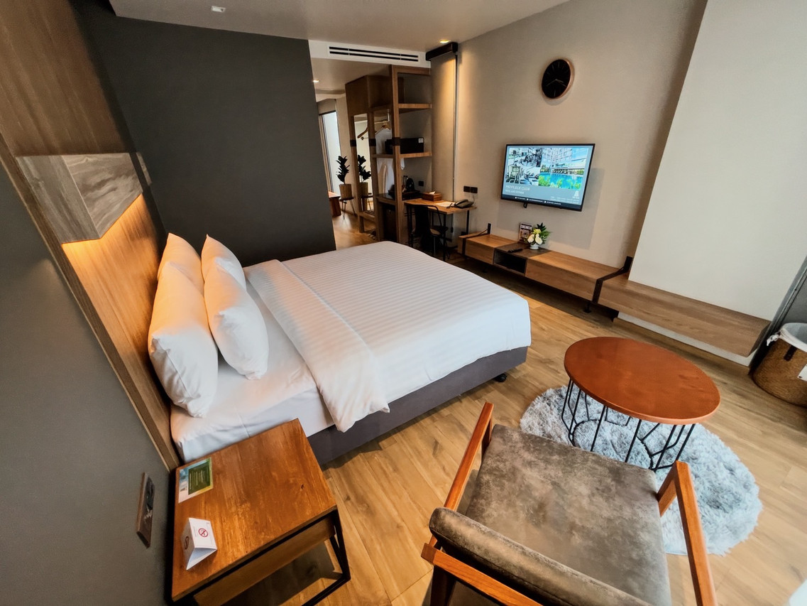 Wood-design guest room with LED-lit headboard and town view