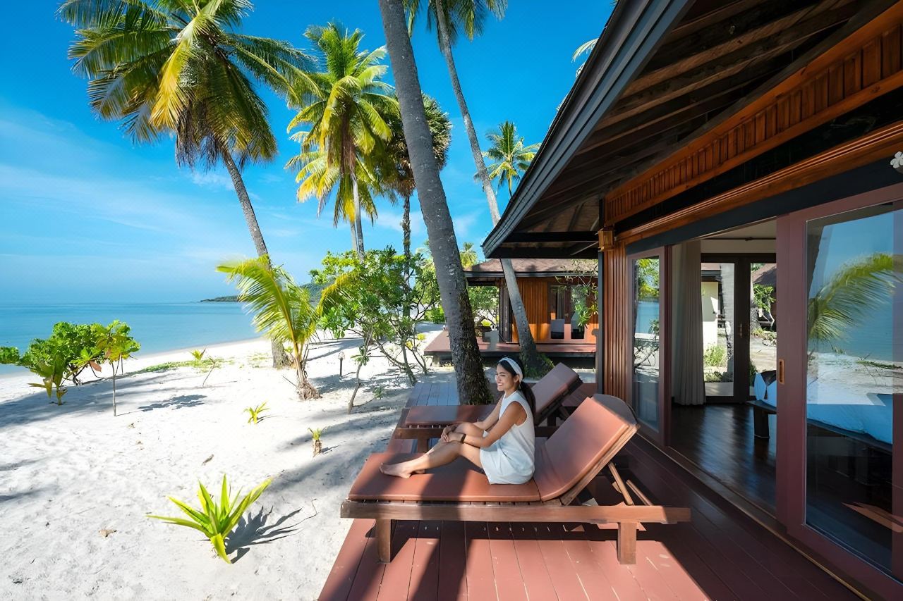 Beachfront villa terrace with sun lounger, sand and the Andaman Sea