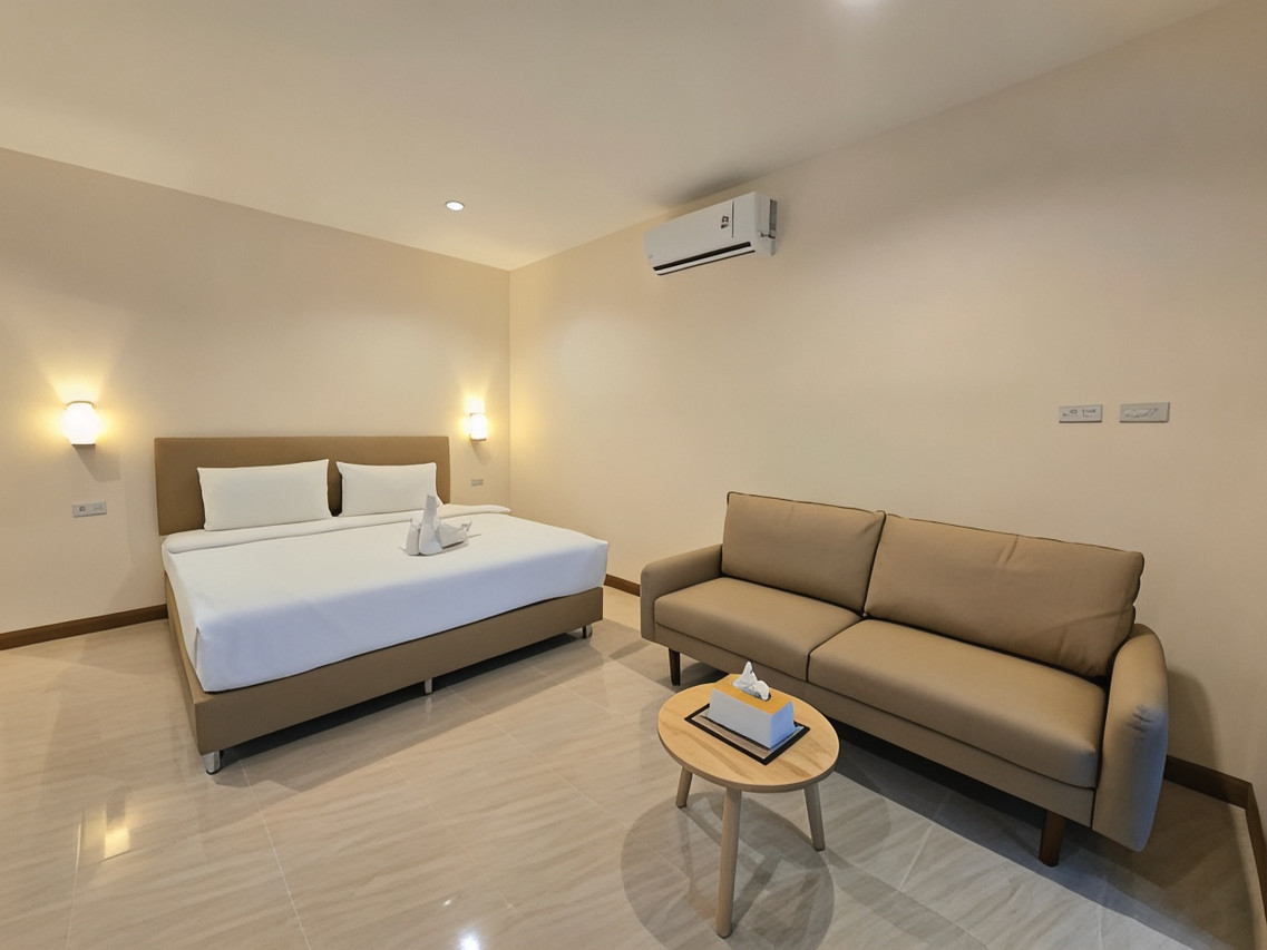 Renovated air-conditioned bungalow with plain walls, sofa and wall-mounted air-con unit