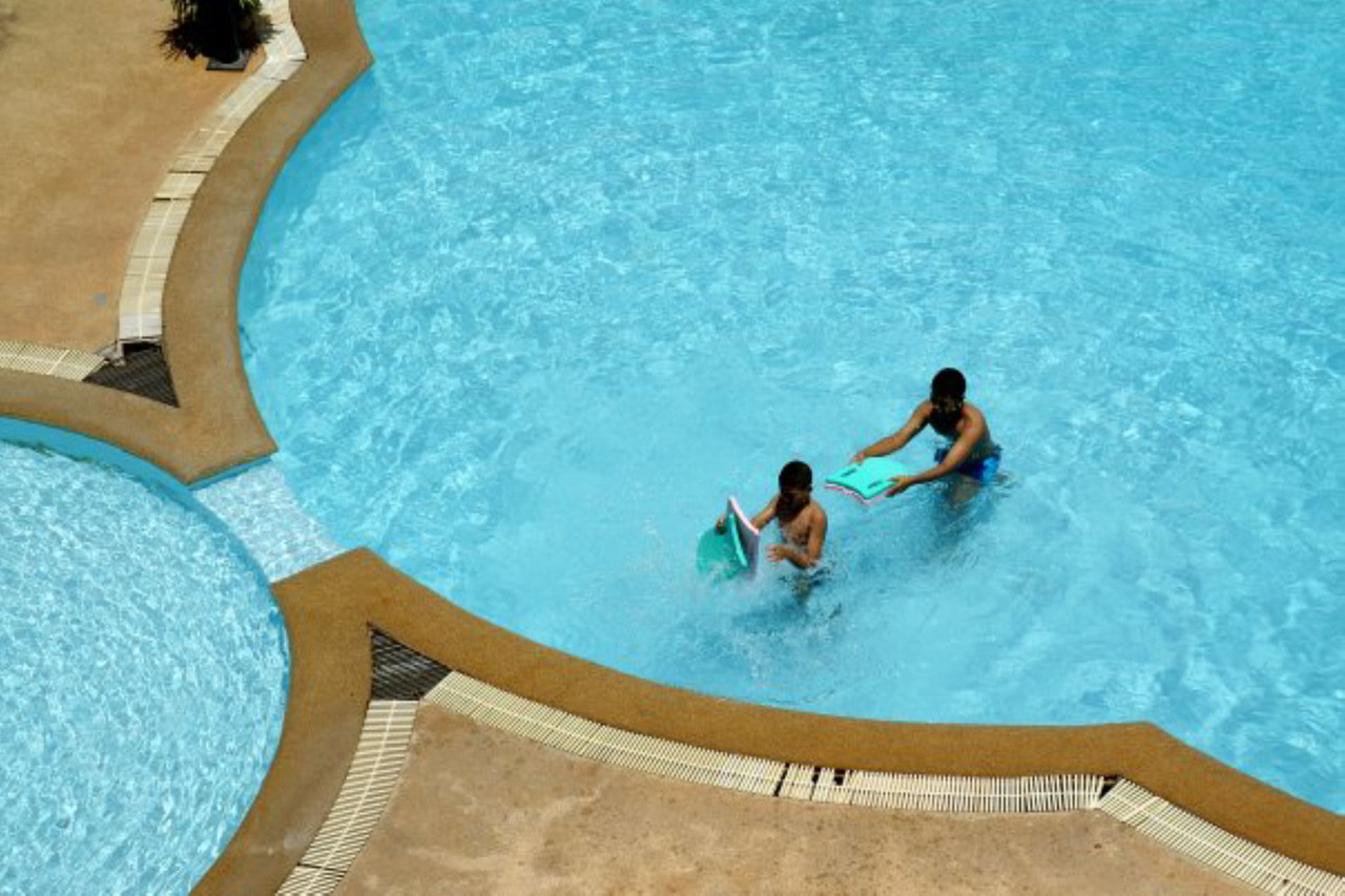 Outdoor pool with a separate children's pool at Thumrin Thana Hotel
