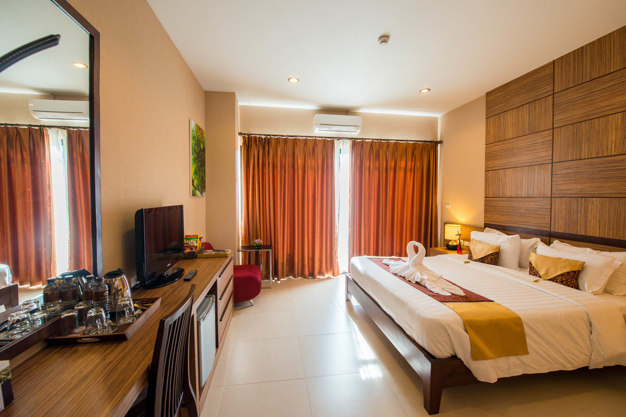 Deluxe room at The Pannarai Hotel Udonthani with a balcony and king bed