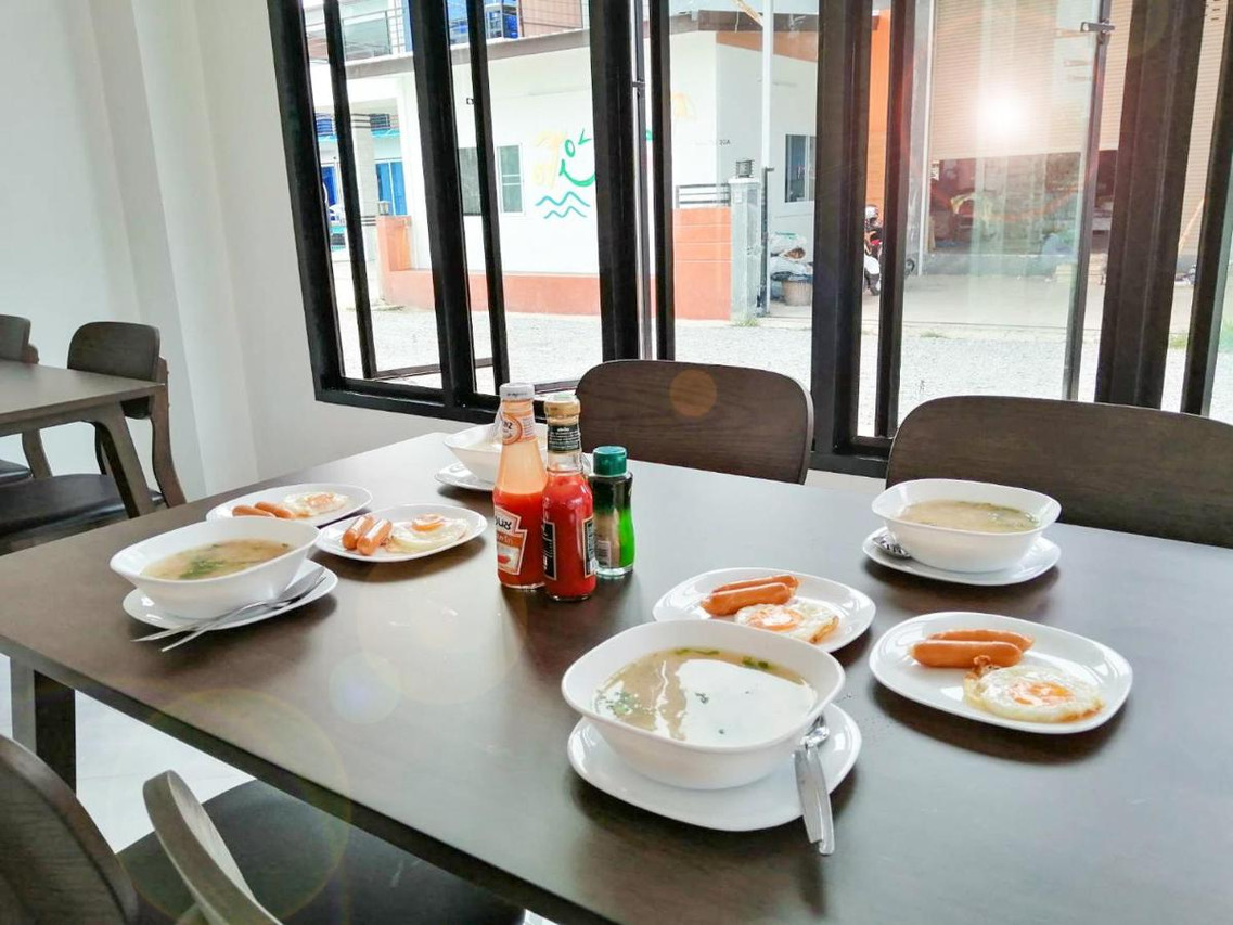 Breakfast table in the resort dining room with fried egg, sausage and soup