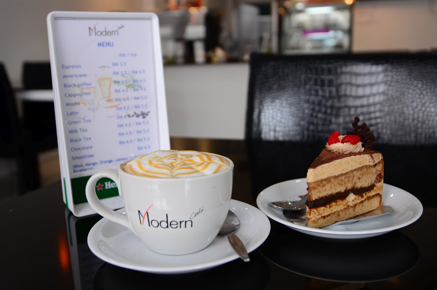 Modern Café on the ground floor with a latte and slice of cake