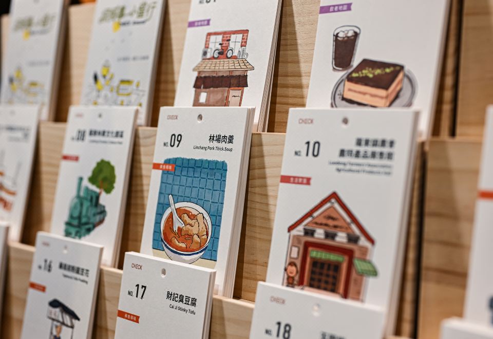 CHECK local-guide cards on display in the hotel lobby — illustrated restaurant and attraction cards for Luodong